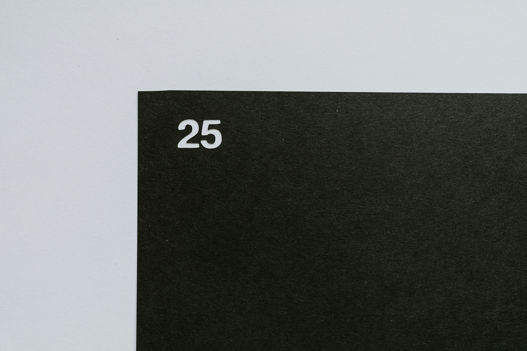 Image shows a black background with the number 25